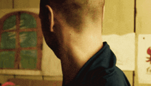 a man 's neck is shown in a blurry photo in front of a window with a red crab on it