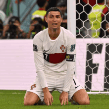 a soccer player kneeling down with the number 10 on his arm