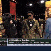 a man in a tuxedo and bow tie is standing in front of a sign that says wr matthew golden on it