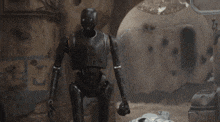 a robot with a helmet on is standing in the dirt