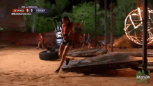 a woman is running on a track with a score of titanes 8 5 heroes