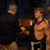 two men are holding a trophy that says survivor 2025
