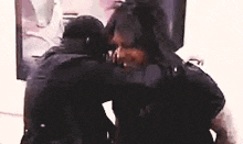 a couple of people are hugging each other in front of a mirror .