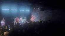 a crowd of people watching a band on stage