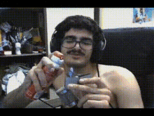 a man wearing headphones and glasses is holding a spray bottle