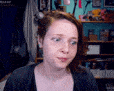 a woman is making a funny face in front of a sign that says resub x67