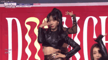 a woman dancing in front of a sign that says show