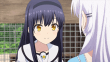 a girl with long black hair and yellow eyes looks at another girl