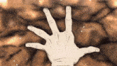 a drawing of a hand reaching out towards a brown background