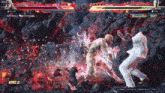 two men are fighting in a video game and one of them is wearing white pants