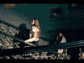 three women are dancing on a stage in a room .
