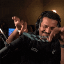 a man wearing headphones and a black shirt that says 107.5