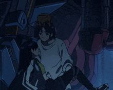a girl with a box on her head is sitting next to a man