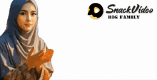 a woman wearing a hijab is standing in front of a banner that says snack video big family
