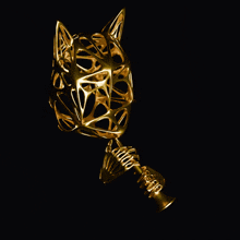 a gold object that looks like a wolf 's head is holding a trophy