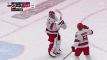 a hockey player with the number 56 on his jersey stands on the ice