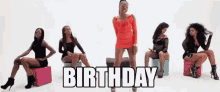 a woman in a red dress is standing in front of a group of women sitting on pink cubes with the words birthday written above them