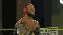a wrestler in a ring with a sign that says gazine 's in the background