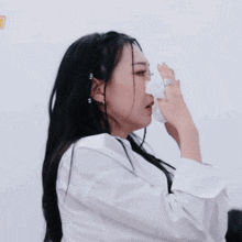 a woman wearing a white shirt has her hands up
