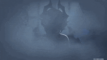 a demon with horns and wings is standing in a dark room surrounded by smoke .