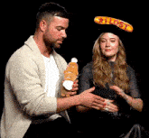 a man holding a stuffed animal next to a woman wearing a hat that says lost