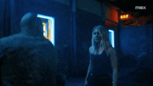 two men are fighting in a dark room and the word max is on the bottom right