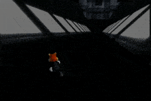 a group of people standing in a dark room looking up at a large orange object