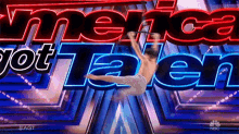 a man is doing a trick in front of a sign that says " america got talent "