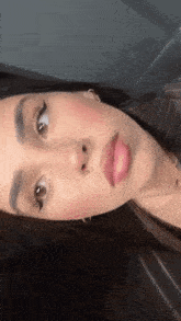 a close up of a woman 's face with her eyes closed and her mouth open