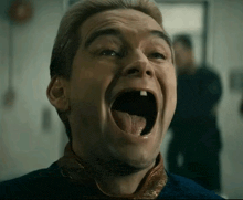 a man is making a funny face with his mouth wide open