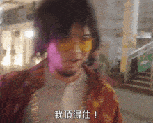a blurry picture of a man wearing yellow sunglasses and a red jacket
