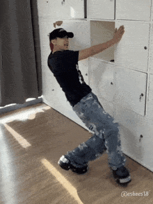 a person is leaning against a wall with the number 18 on the bottom