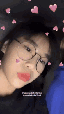 a close up of a woman wearing glasses with hearts around her