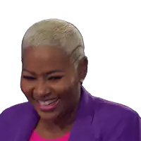 a woman wearing a purple jacket and pink shirt is smiling