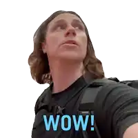a man with long hair is wearing a black shirt with wow written on it