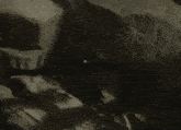 a close up of a rocky surface with a few pieces of paper on it