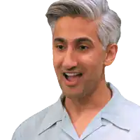 a man with gray hair is wearing a blue shirt