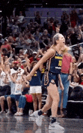 a female basketball player wearing a jersey that says indians on it