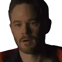 a close up of a man 's face with a beard