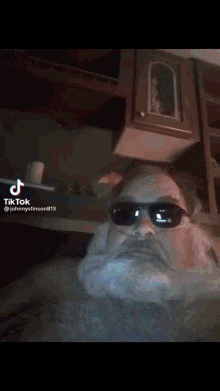 a tiktok video of a man with a beard is being shared