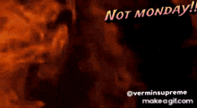 a man with a beard and a hat says " not monday " in front of a fire background