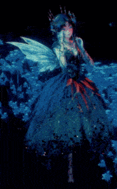a fairy in a blue dress with wings and a crown on her head