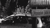 a car is parked in front of a sign that says herouxtville