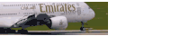 an emirates plane is taking off from an airport runway
