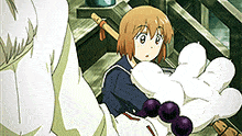 a girl in a sailor uniform is holding a white glove with purple beads .