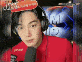 a young man wearing headphones and a red shirt with the date of 2021.01.21