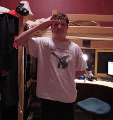 a young man wearing a shirt that says glory to the vaktonian empire salutes