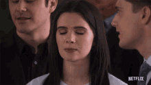 a netflix ad shows a woman with her eyes closed in a crowd