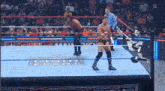 two wrestlers are in a wrestling ring with a referee watching