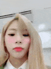 a close up of a woman 's face with long blonde hair